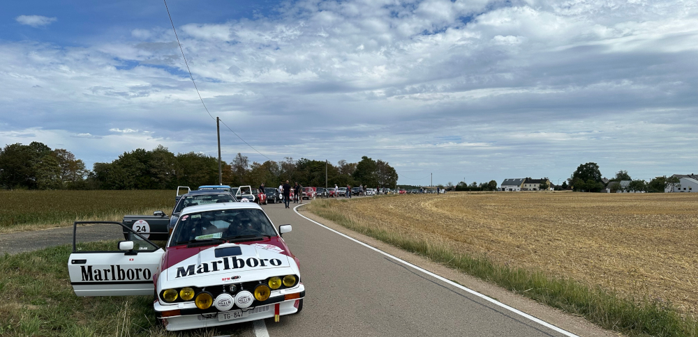 A Marlboro-branded Alfa Romeo Alfetta GTV6 stands in front of other cars